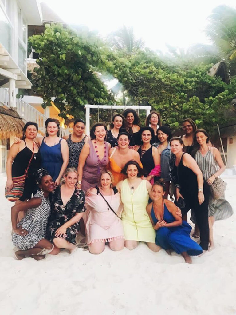 A group of women on the beach in Tulum, Mexico, at the AstroStyle astrology retreat.