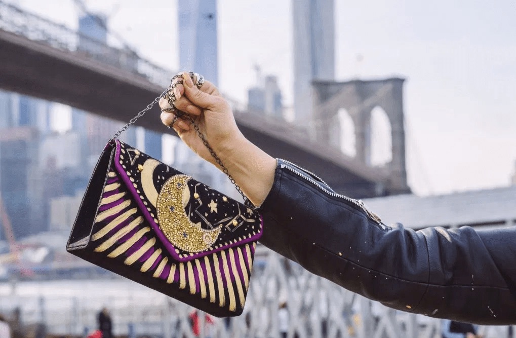 A bag with a moon design and a background of New York City by designer Valentina Perissi, who shares her top fashion career tips.