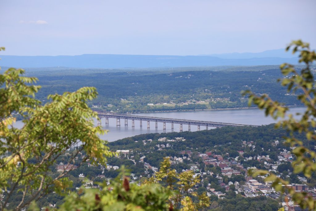 View of the ocean, mountain, sky, and greenery from the top of Mount Beacon.
