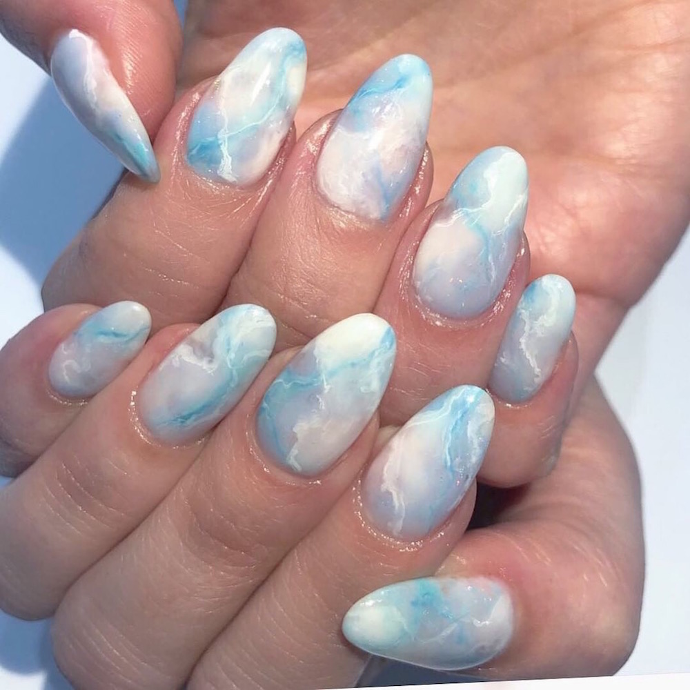 Close up of blue cloud design nails by Rose B. at the Leafgel seminar.