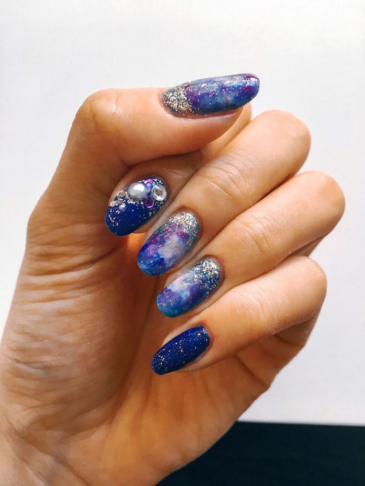 Leafgel - one hand with dark blue, pearl, and glitter design by VW Nail Bar.