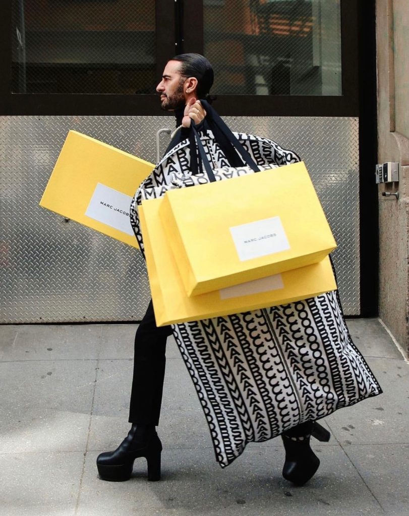 Designer Marc Jacobs carrying bright yellow bags in New York City.