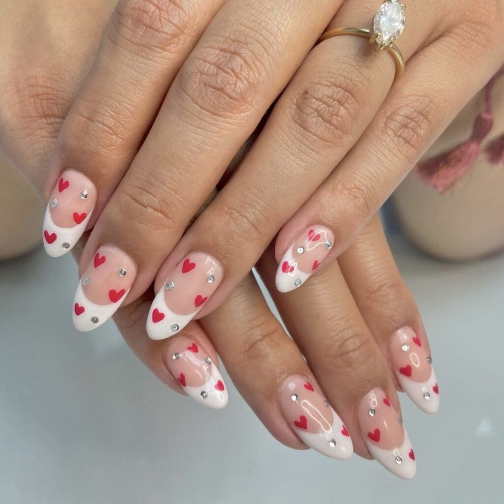 french manicure with red hearts and silver rhinestones.