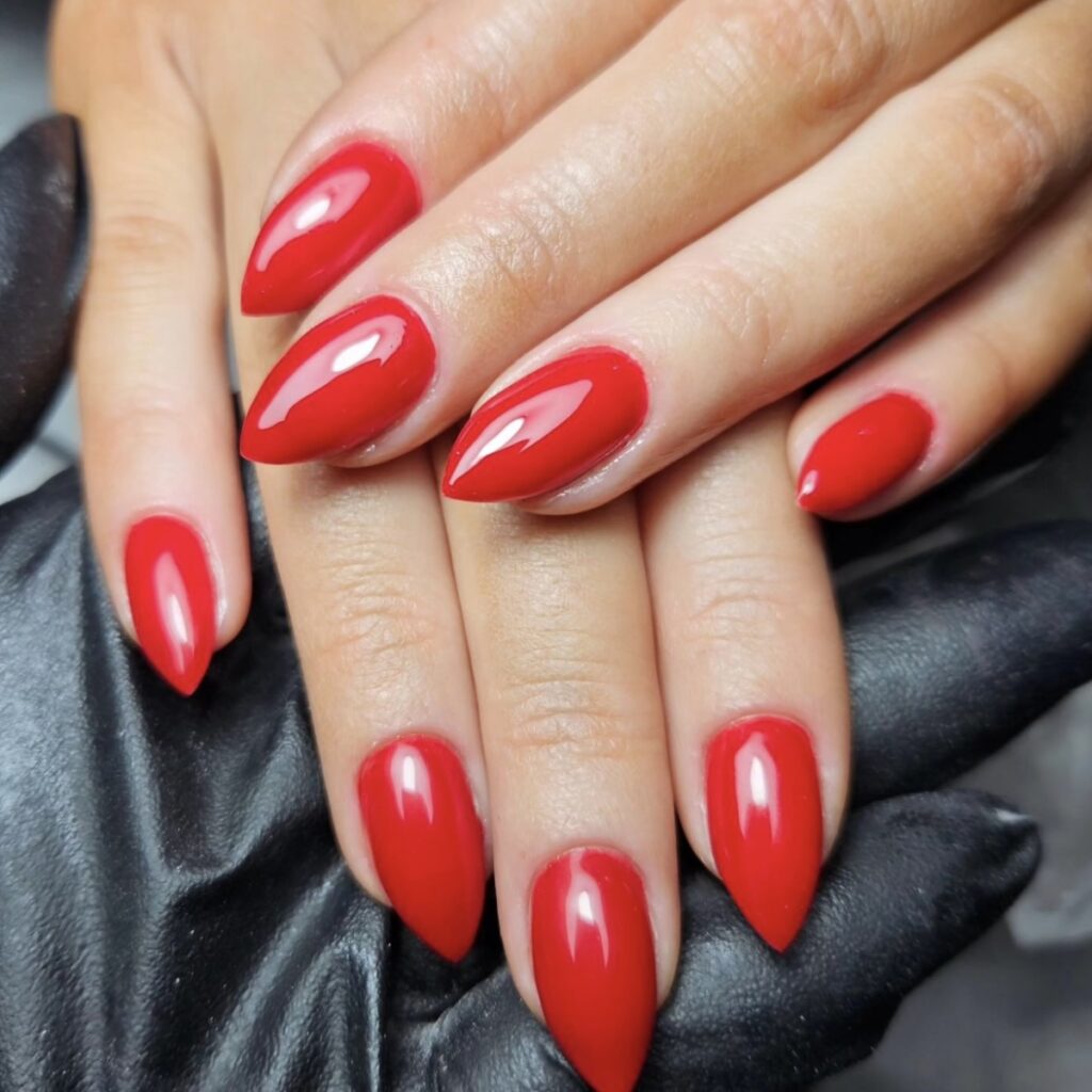 red nails medium-length nails with pointed tips.
