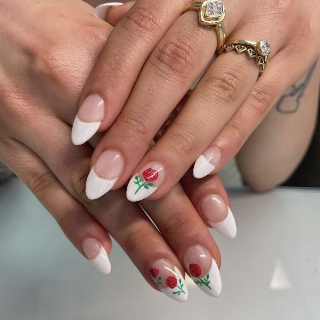 short manicure with french tips and rose designs.