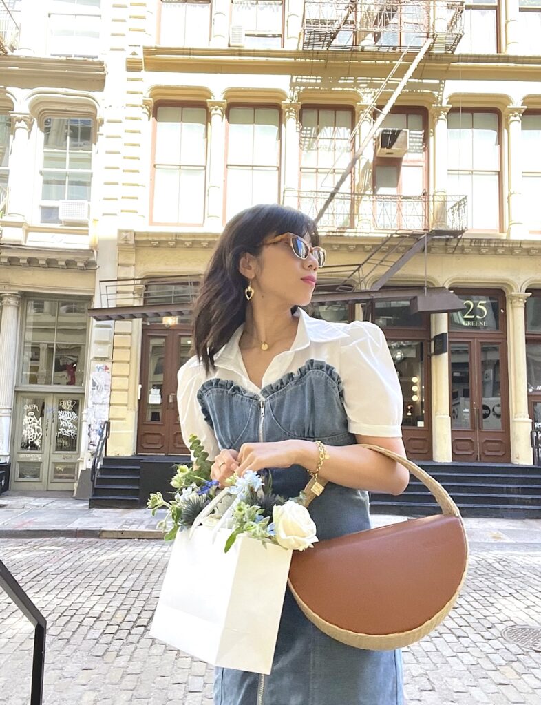Wendy Sy with a straw bag in Soho, NYC.