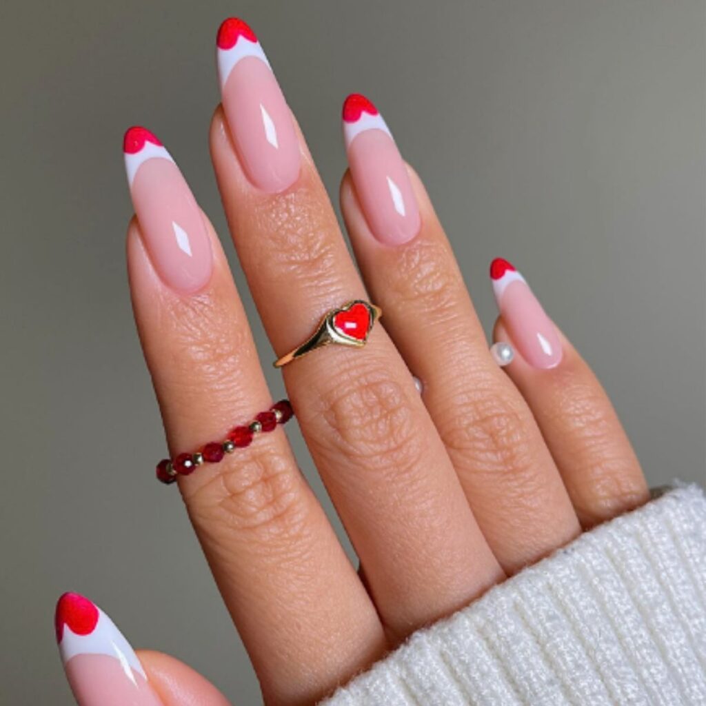 Close up of french tips with red hearts.