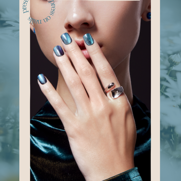 close up of shiny press-on nails on a green background