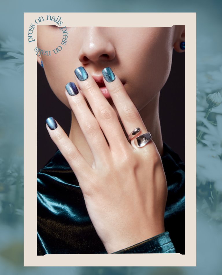 close up of shiny press-on nails on a green background