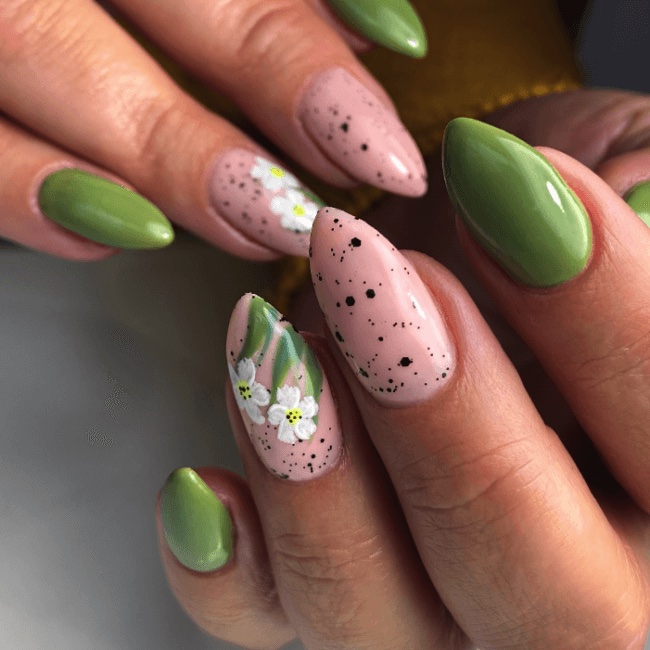 Two hands showing green nails with a white floral design and polka dots, best summer nail designs 2026