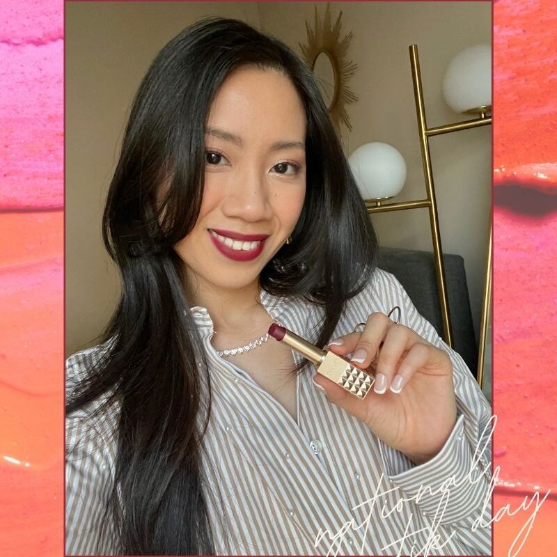 Holding red lipstick, celebrating National Lipstick Day 2025 sales.