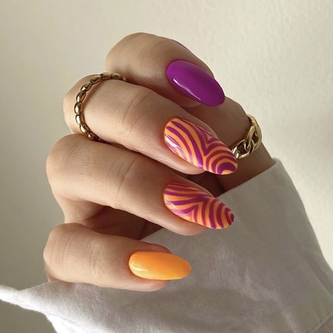 Abstract swirl summer nails with a purple and orange design