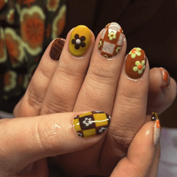 A hand with floral autumn nail art
