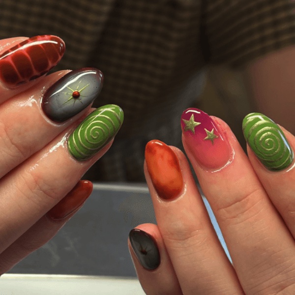 A hand with different colors with an autumn nails design theme