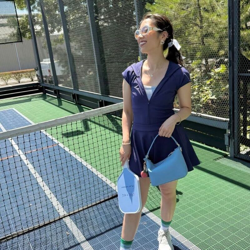 Wearing a blue pickleball outfit outdoors on a sunny day