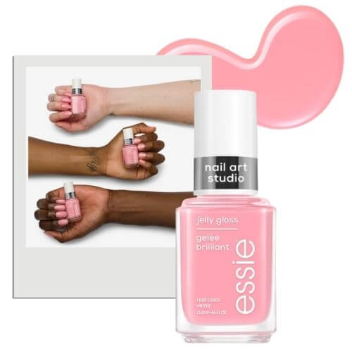 essie blush pink nails and bottle of nail polish on a white background