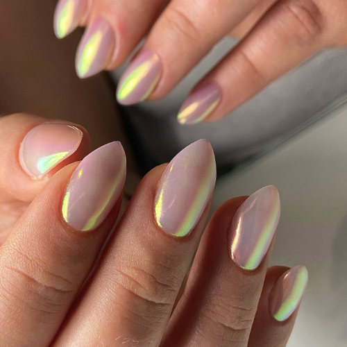 light pink nails with a metallic finish and pointed tips.