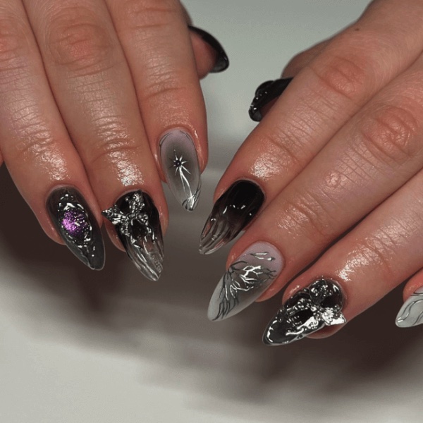 A hand with dark coquette nails and a white background, one of the top autumn nail designs