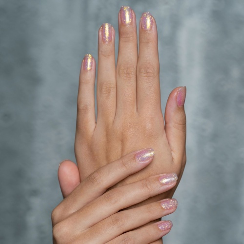 short rose gold nails with a glitter top coat.