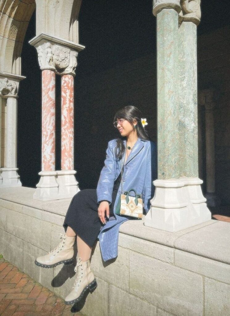 Beige combat boots with a museum background, a top 2026 fall boots trend.