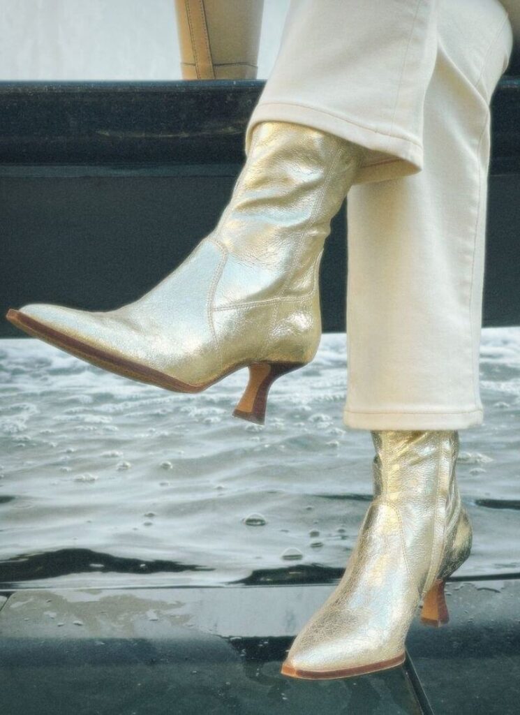 Gold metallic shoes with a fountain background.