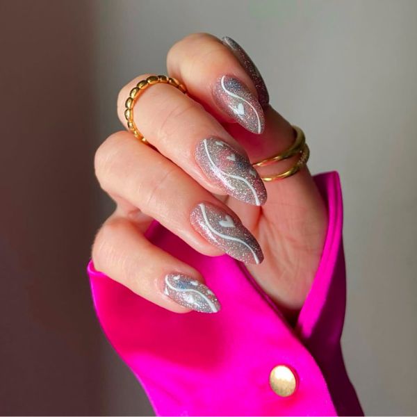 metallic winter nails with a pink sleeve and gray background.