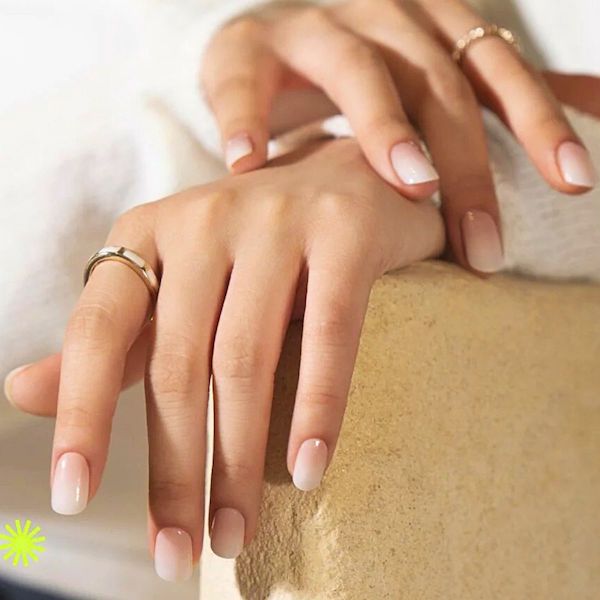 Close up of soap nails on a white and beige background.