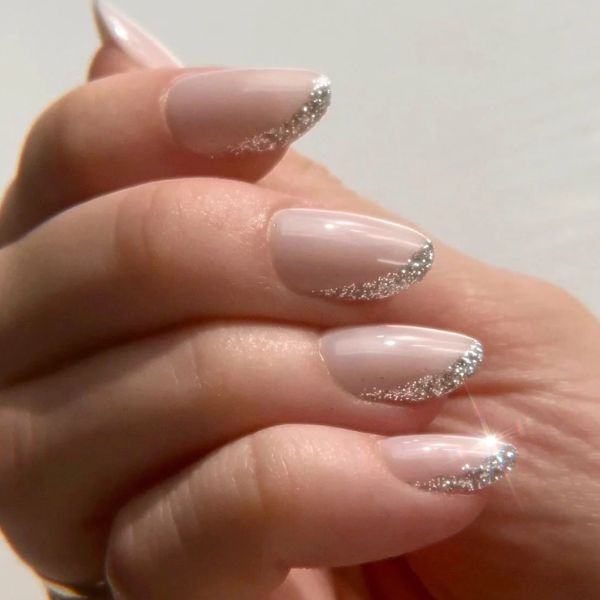 close up of a hand with neutral manicure and shiny tips, one of the top 2026 nail color trends.