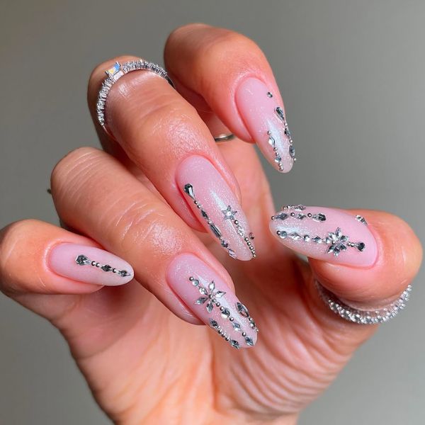 Pink holiday manicure with a gray background
