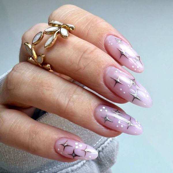 pink sparkle manicure with a light blue background