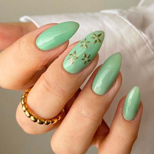 Close up of mint green nails with a white long sleeve.