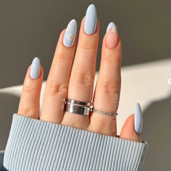Blue floral mani on a beige background.