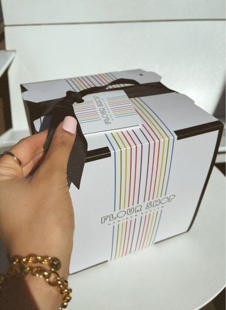 Opening a white gift box as a summer birthday gift