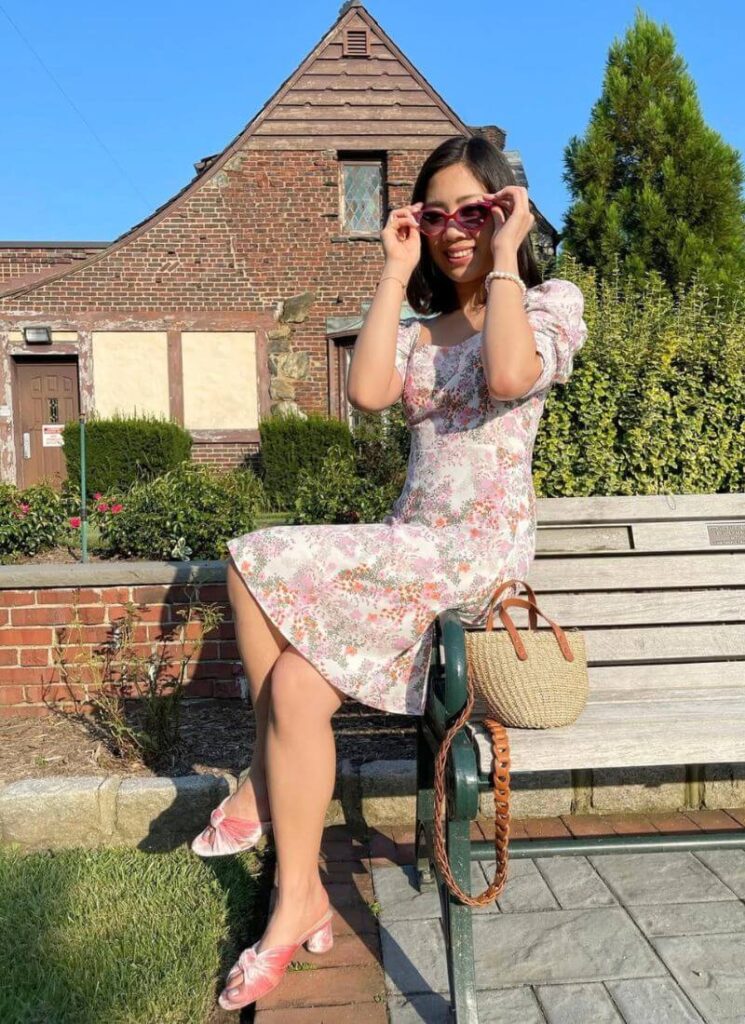 Pink velvet block heel sandals worn outdoors, a stable and stylish summer shoe.