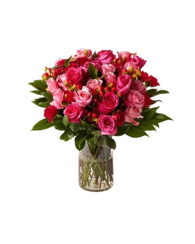 UrbanStems Triple the Verona pink roses with green leaves in a clear vase